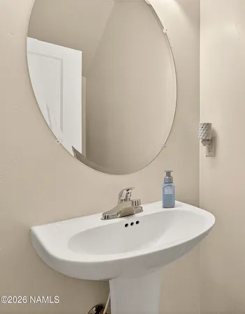 a bathroom with a sink and mirror