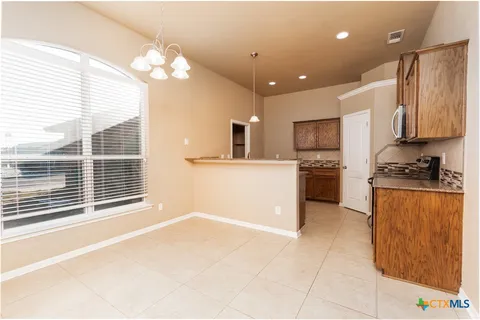 a kitchen with stainless steel appliances granite countertop a refrigerator sink and cabinets
