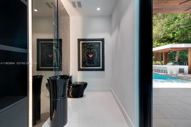 a bathroom with a sink mirror toilet and shower