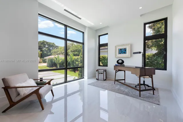 a spacious bedroom with a large bed and a large window