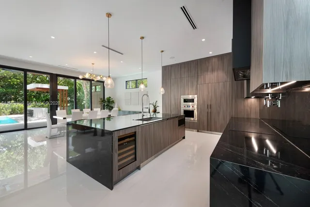 a large kitchen with kitchen island a large counter top