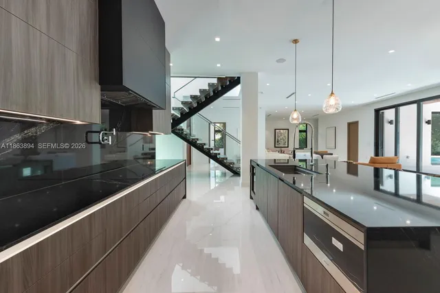 a living room with furniture and large windows