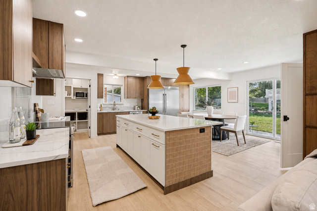 1168 East Center Street Bountiful, UT 84010 - Photo 6 of 38 Open-concept kitchen featuring an oversized island with white cabinetry and a textured wood-finish facade