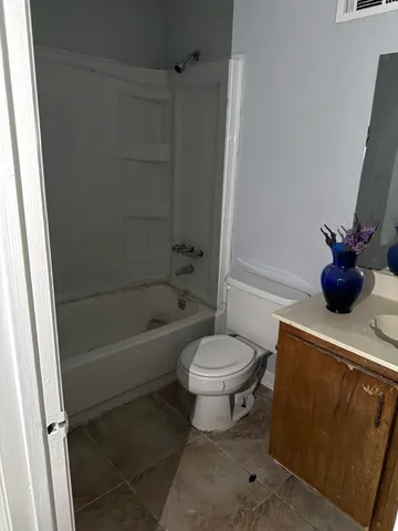a bathroom with a toilet and a bathtub