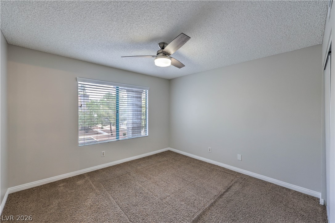 1575 West Warm Springs Road, Unit 322 Henderson, NV 89014 - Photo 18 of 25 This spacious bedroom offers ample natural light and a comfortable atmosphere for relaxation.