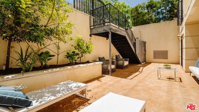 a view of balcony with wooden floor and a potted plant