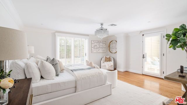 a bedroom with bed and a large window