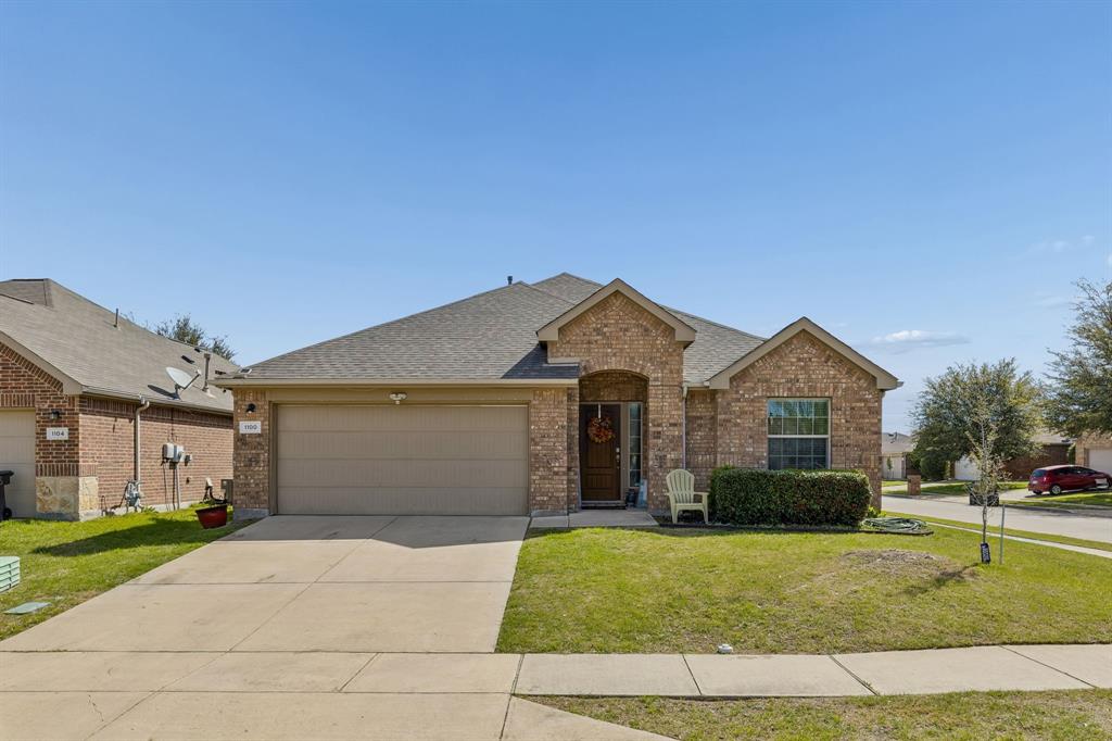 1100 Diablo Pass Fort Worth, TX 76052 - Photo 1 of 1 a front view of a house with a yard and garage