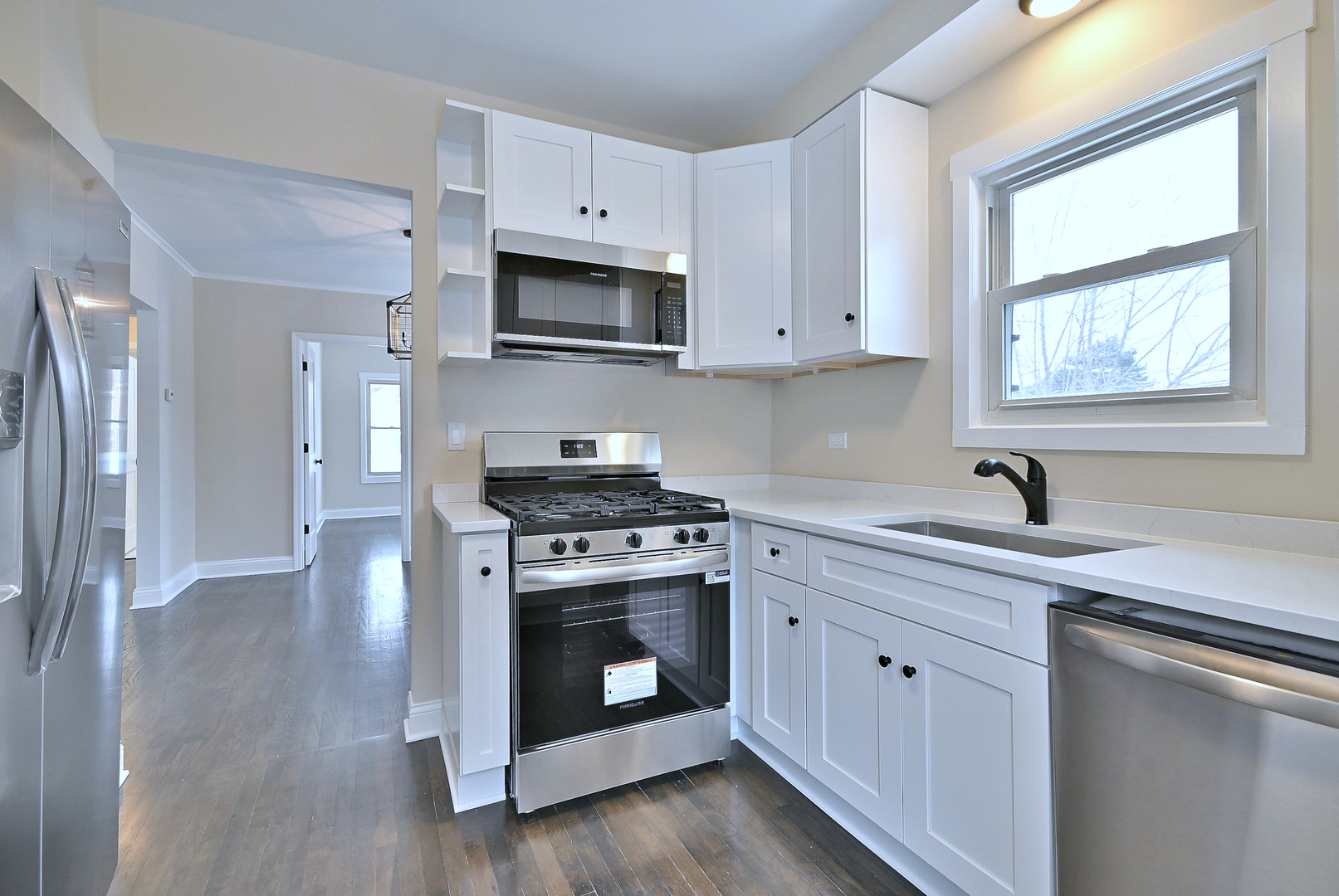 9016 Southview Avenue Brookfield, IL 60513 - Photo 21 of 45 a kitchen with stainless steel appliances a stove a sink and a microwave