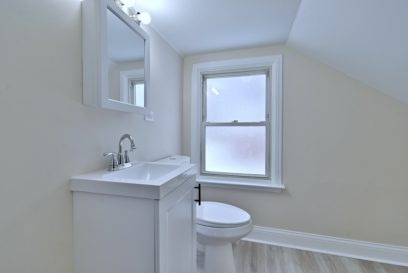 9016 Southview Avenue Brookfield, IL 60513 - Photo 38 of 45 a bathroom with a toilet sink vanity and mirror