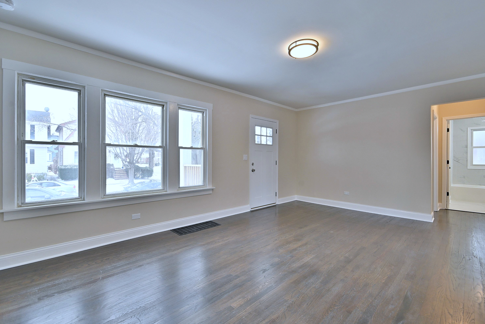 9016 Southview Avenue Brookfield, IL 60513 - Photo 5 of 45 an empty room with wooden floor and windows