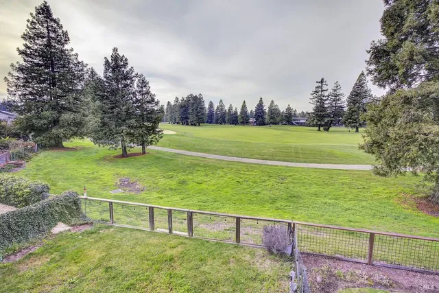 a large kitchen with stainless steel appliances kitchen island granite countertop a refrigerator and a stove top oven