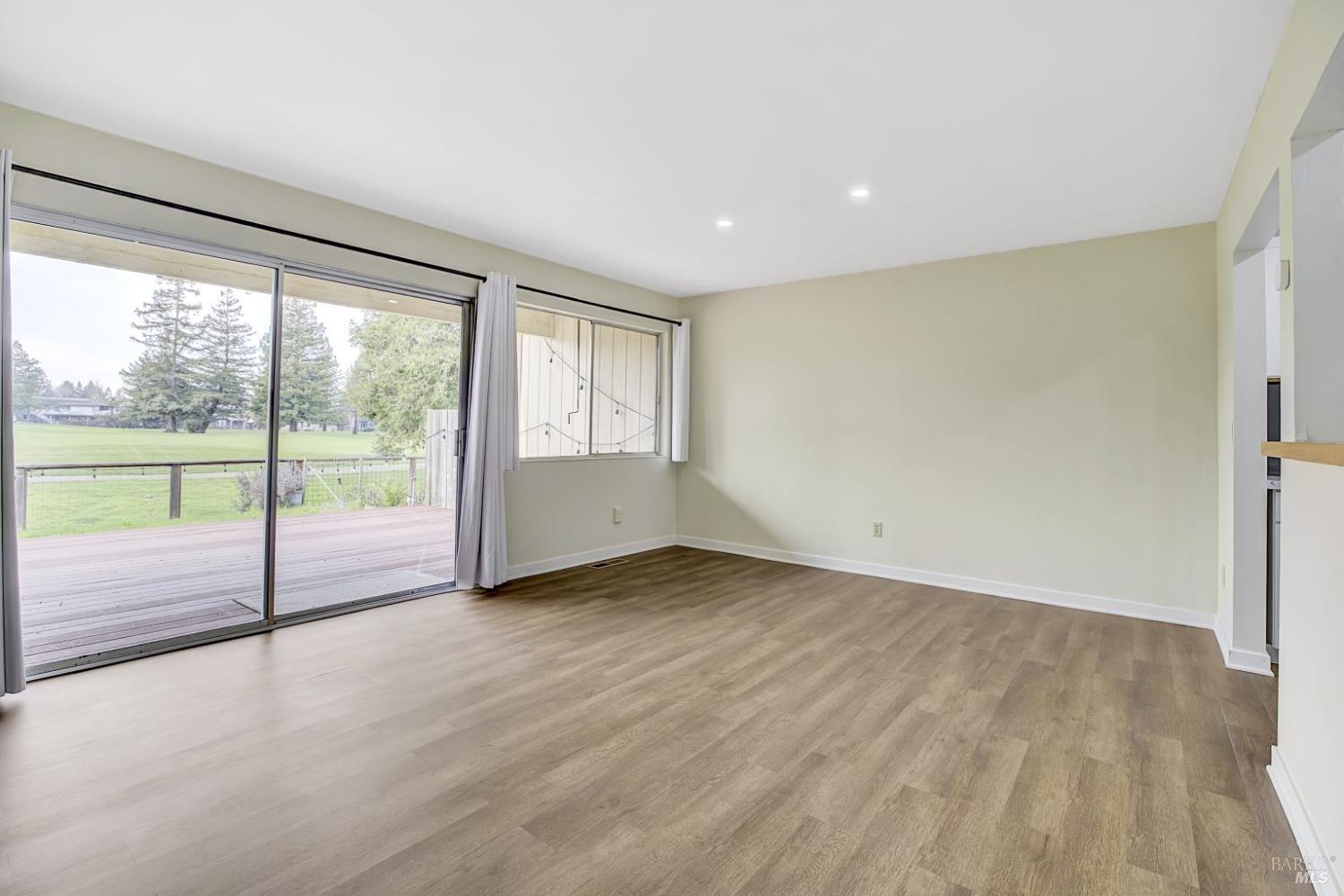 870 Hudis Street Rohnert Park, CA 94928 - Photo 11 of 49 an empty room with wooden floor and windows