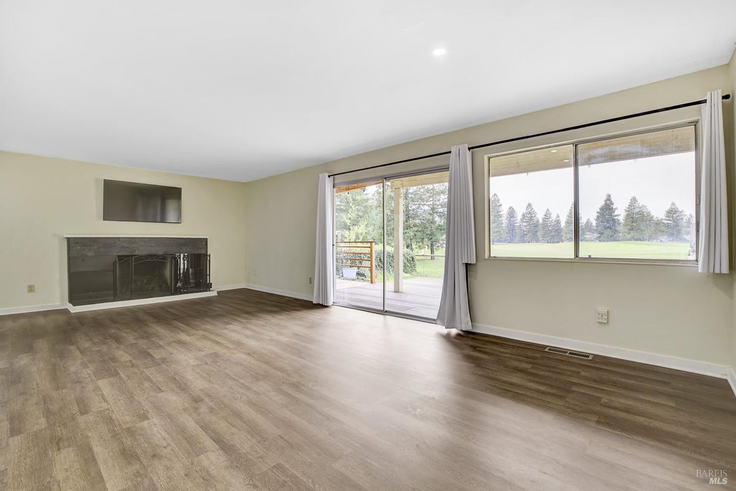 870 Hudis Street Rohnert Park, CA 94928 - Photo 13 of 49 wooden floor fireplace and windows in an empty room