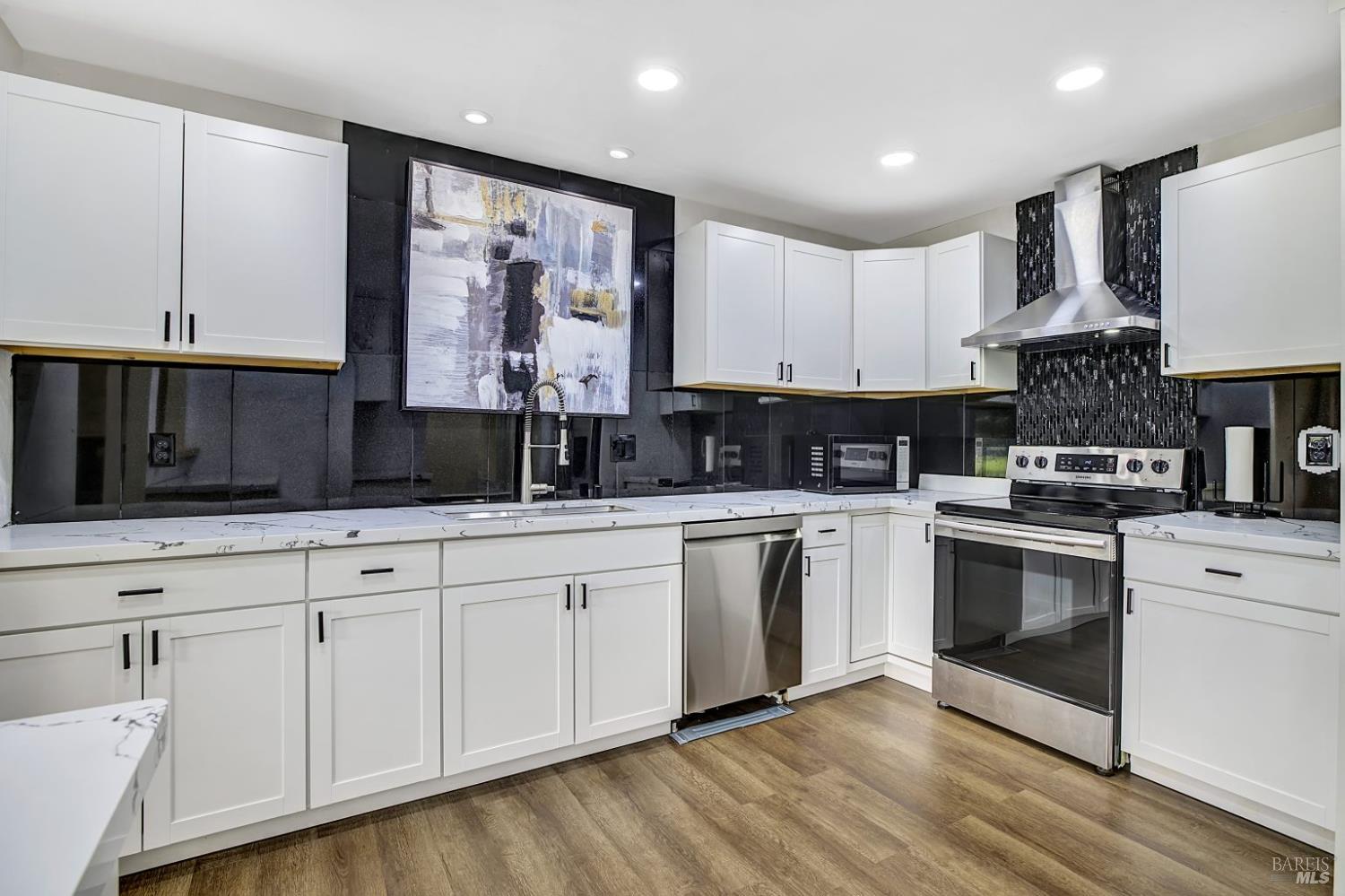 870 Hudis Street Rohnert Park, CA 94928 - Photo 6 of 49 a kitchen with stainless steel appliances granite countertop a stove a sink and white cabinets