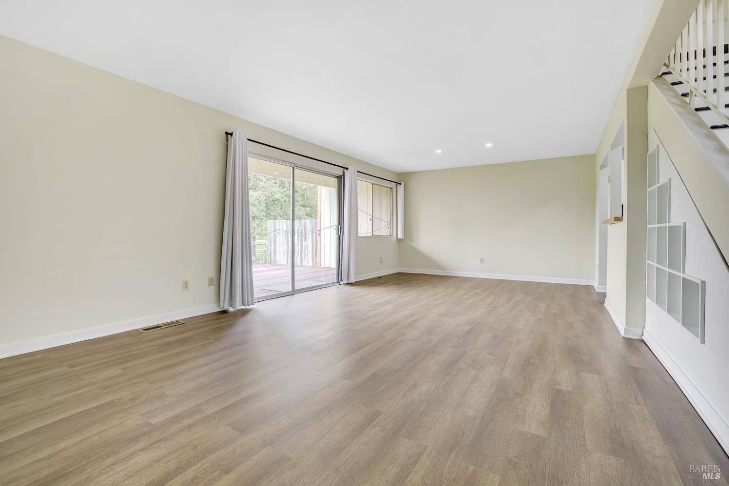 870 Hudis Street Rohnert Park, CA 94928 - Photo 10 of 49 a view of an empty room with wooden floor and a window