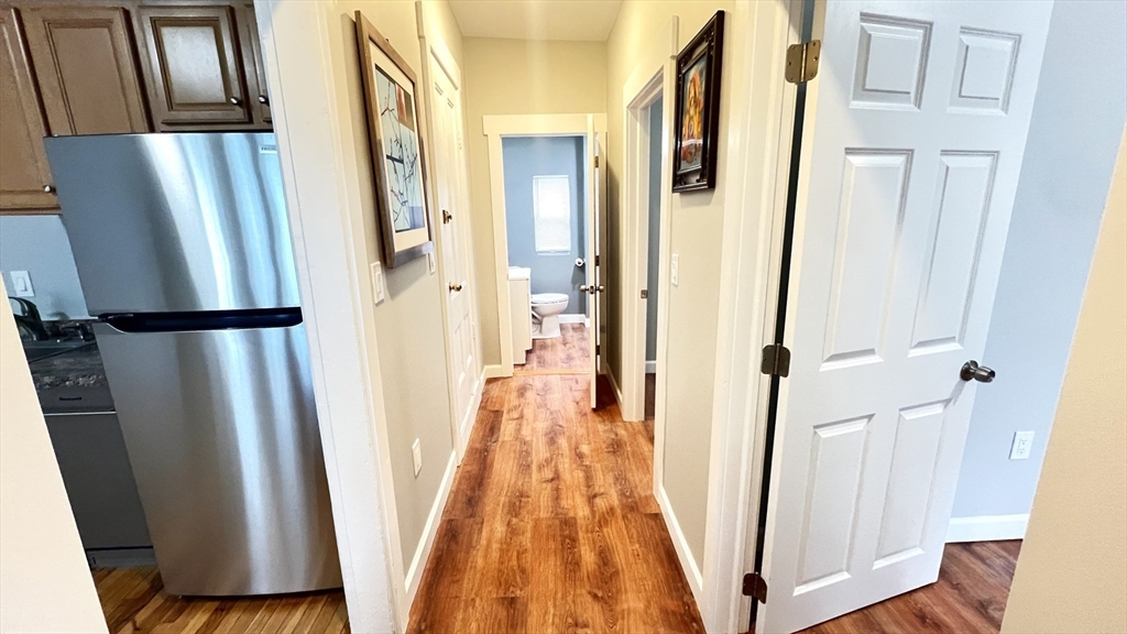 31 Ridgeway Street, Unit 1 Lynn, MA 01902 - Photo 9 of 16 a view of a hallway with wooden floor and stairs