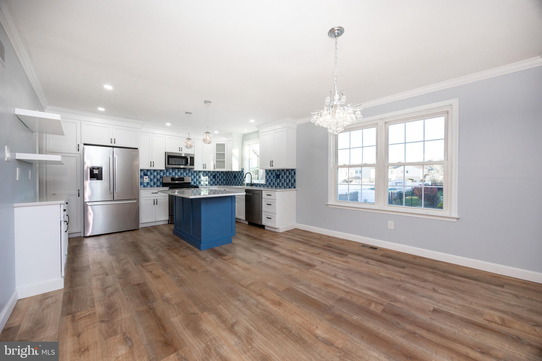 5 Cheyenne Road Royersford, PA 19468 - Photo 11 of 29 a kitchen with stainless steel appliances kitchen island granite countertop a refrigerator oven a sink dishwasher and white cabinets with wooden floor