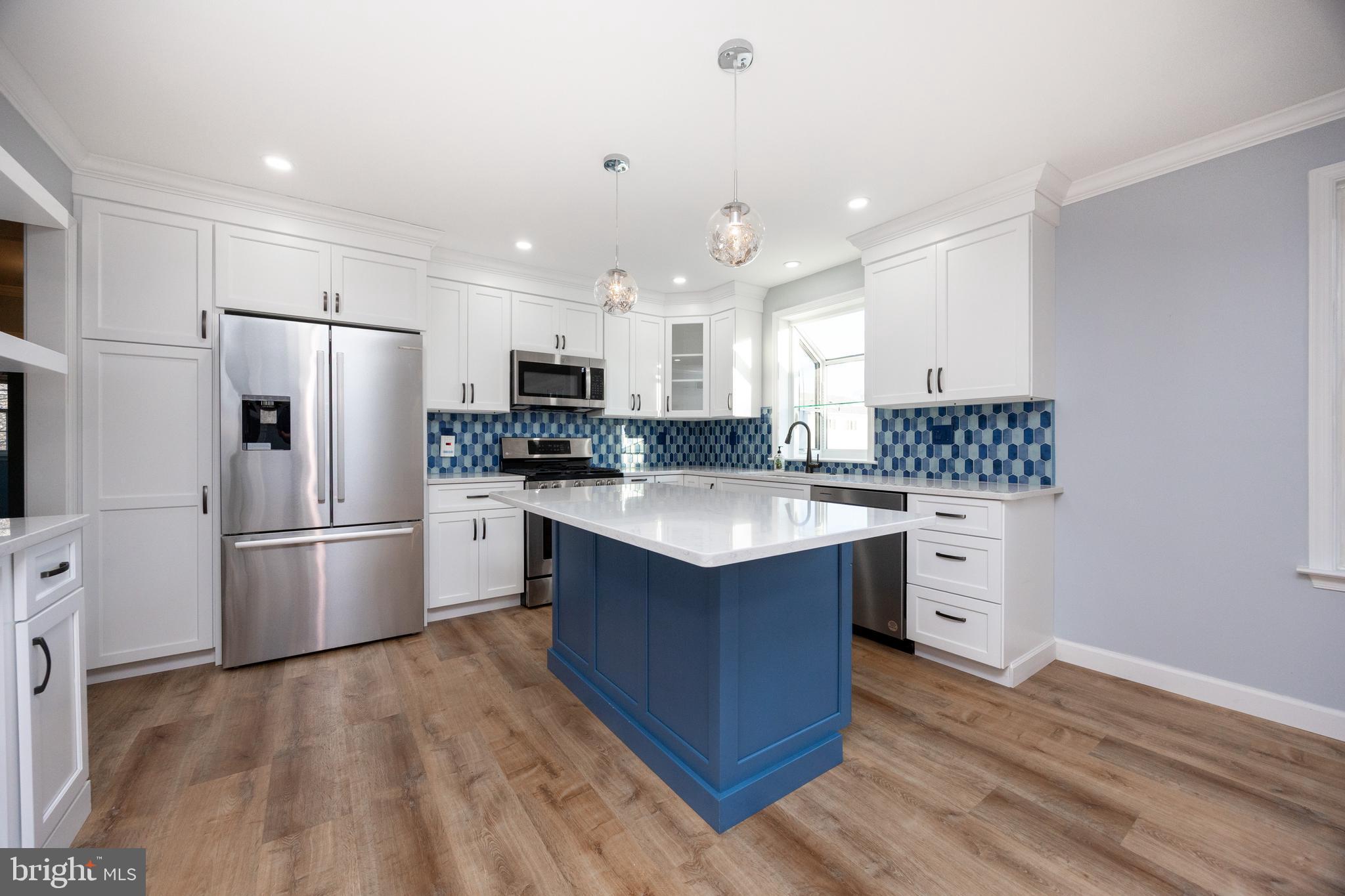 5 Cheyenne Road Royersford, PA 19468 - Photo 10 of 29 a kitchen with stainless steel appliances granite countertop a sink stove a refrigerator and white cabinets with wooden floor