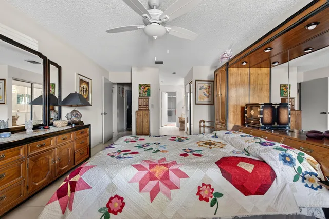 a bedroom with a large bed and a flat screen tv