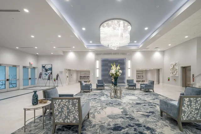 a lobby with furniture and a potted plant