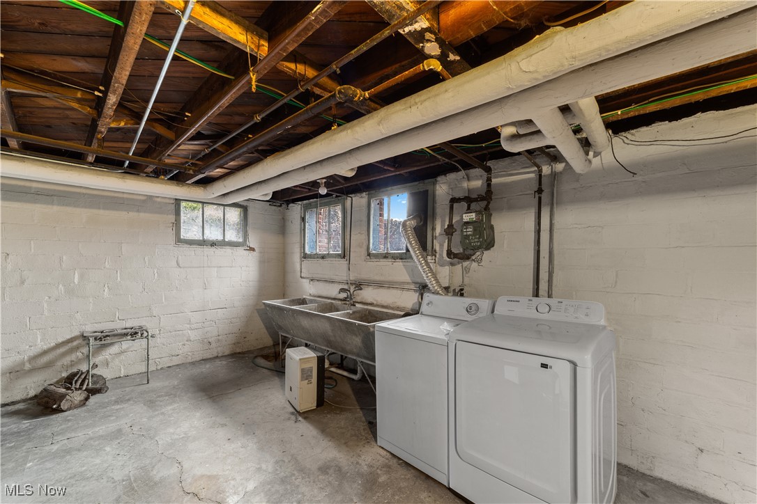 2891 Huntington Road Cleveland, OH 44120 - Photo 37 of 44 Below grade area with washing machine and dryer and a sink