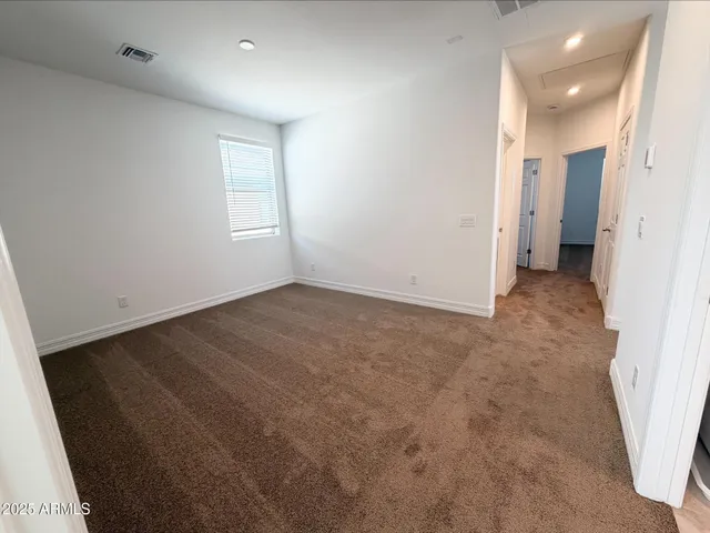 an empty room with a bathroom and a sink