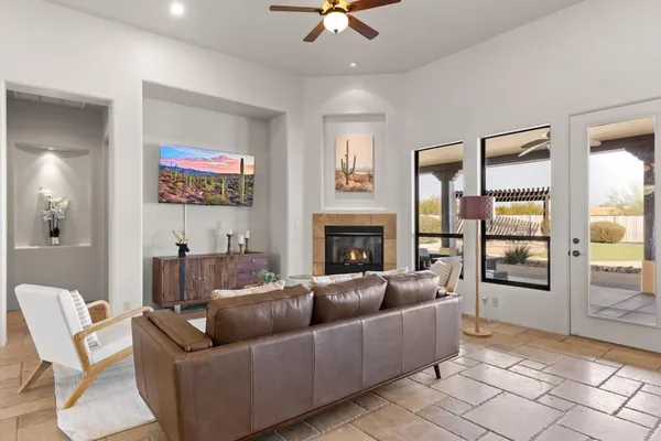 a living room with furniture a fireplace and a flat screen tv