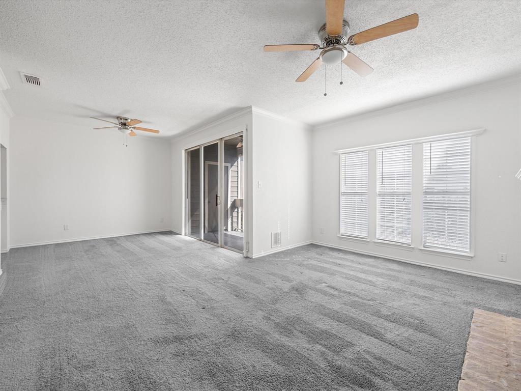5310 Keller Springs Road, Unit 332 Dallas, TX 75248 - Photo 6 of 39 Carpeted empty room with a ceiling fan, a textured ceiling, and crown molding