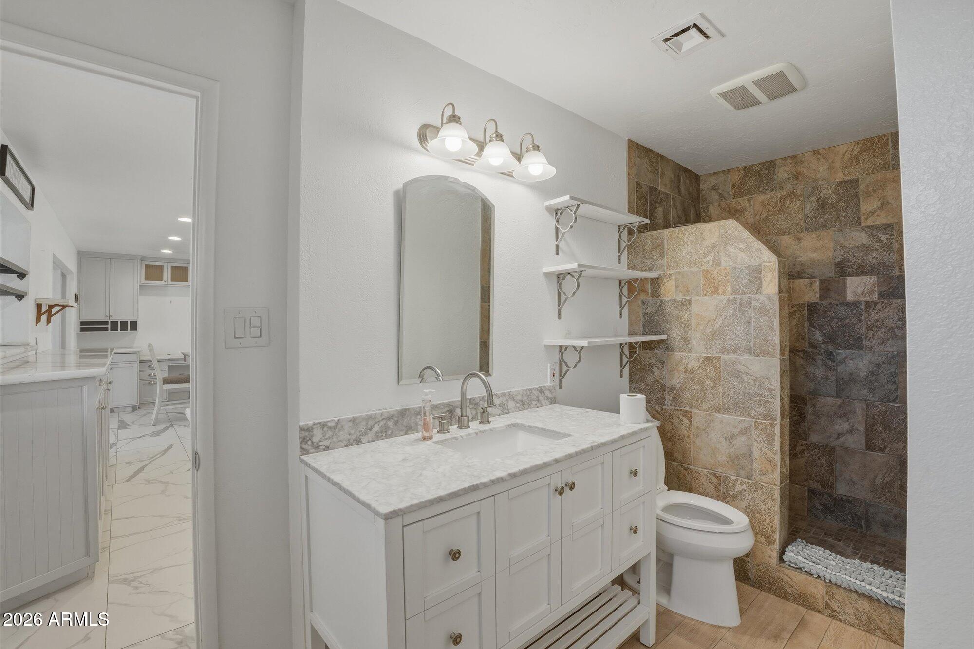 1532 West Loma Lane Phoenix, AZ 85021 - Photo 12 of 19 a bathroom with a double vanity sink mirror and toilet