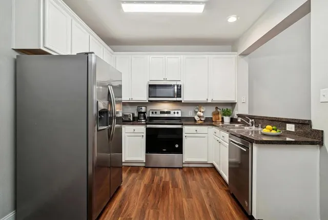 a kitchen with a refrigerator stove and microwave