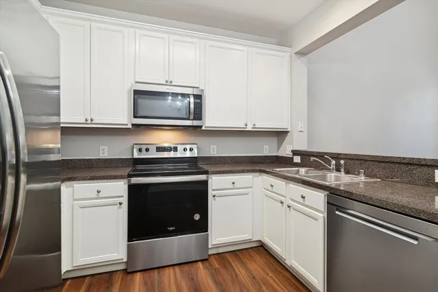 a kitchen with granite countertop a sink and a stove top oven