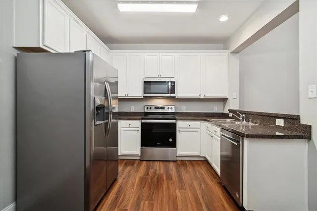 a kitchen with a sink stove and refrigerator