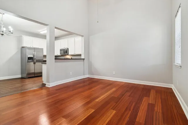 a view of a kitchen with wooden floor and a sink