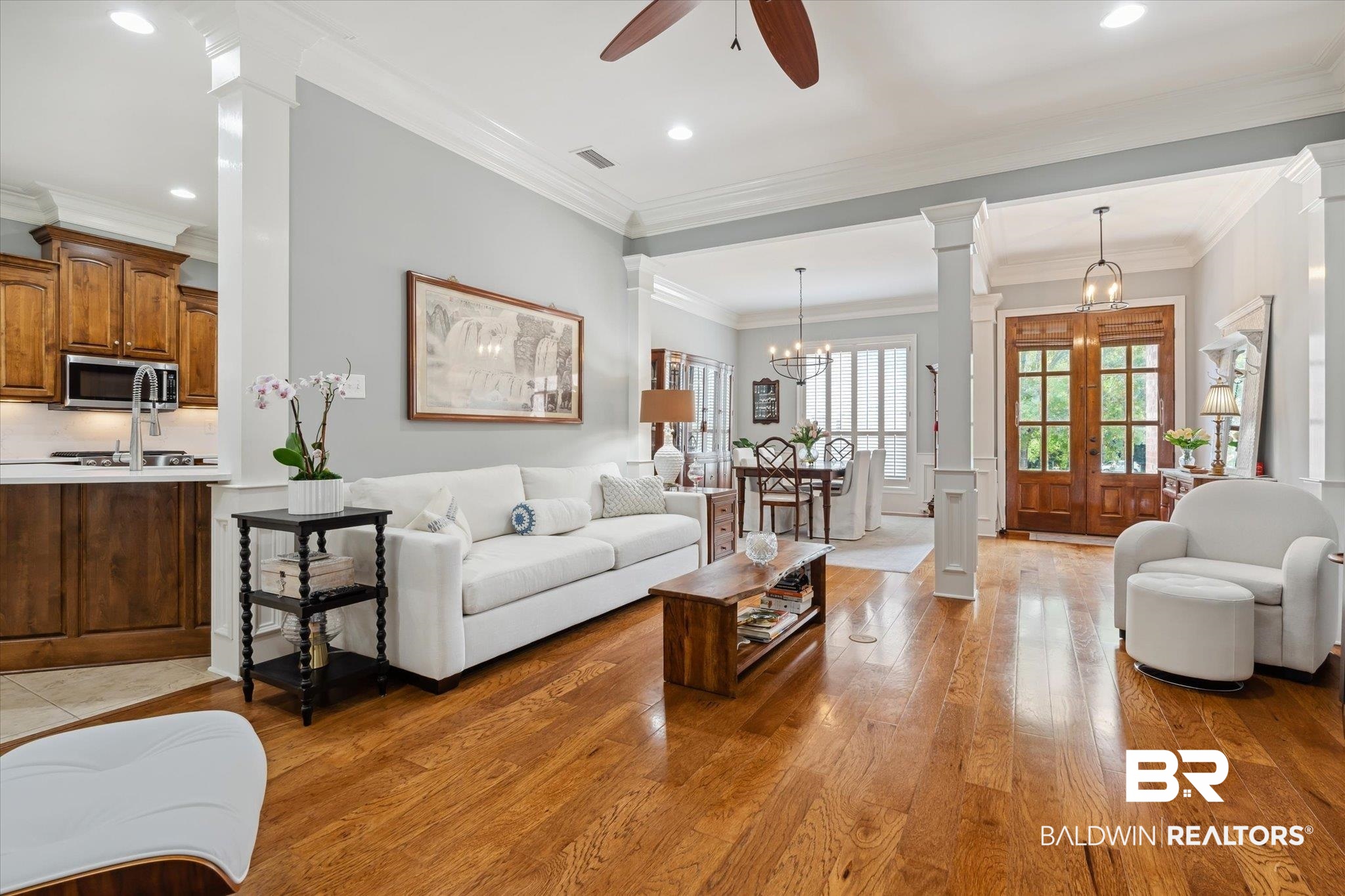 804 Country Club Road Mobile, AL 36609 - Photo 3 of 63 Living room featuring hardwood / wood-style flooring, ceiling fan with notable chandelier, crown molding, and ornate columns