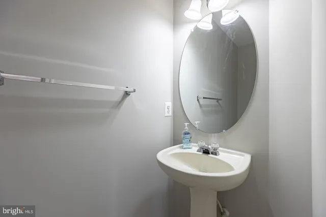 a bathroom with a sink a mirror and a toilet