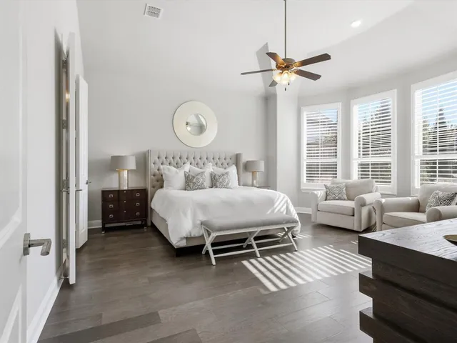 a bedroom with a bed couch and window