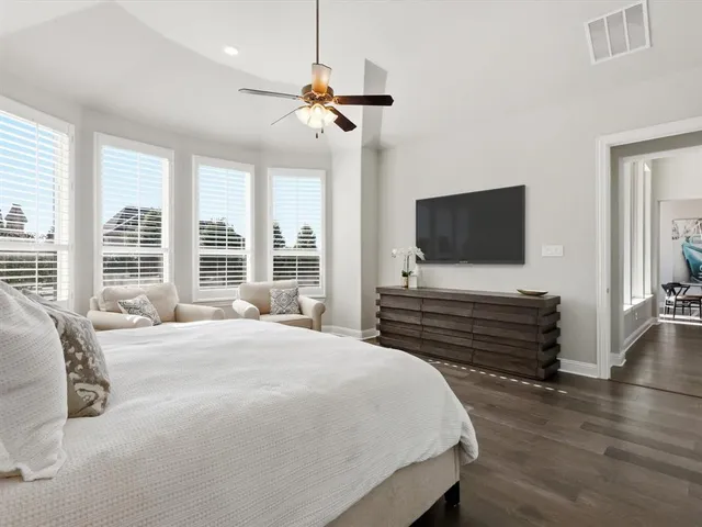 a bedroom with a bed and a flat screen tv