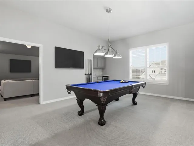 a room with pool table and a flat screen tv
