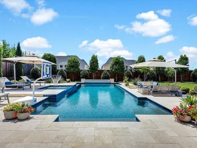 a view of a swimming pool with lounge chairs
