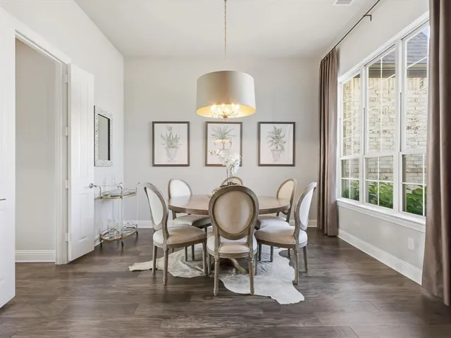 a dining room with furniture window and wooden floor