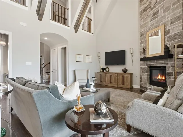 a living room with furniture flat screen tv and a fireplace