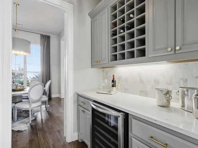 a kitchen with a sink a stove cabinets and a dining table
