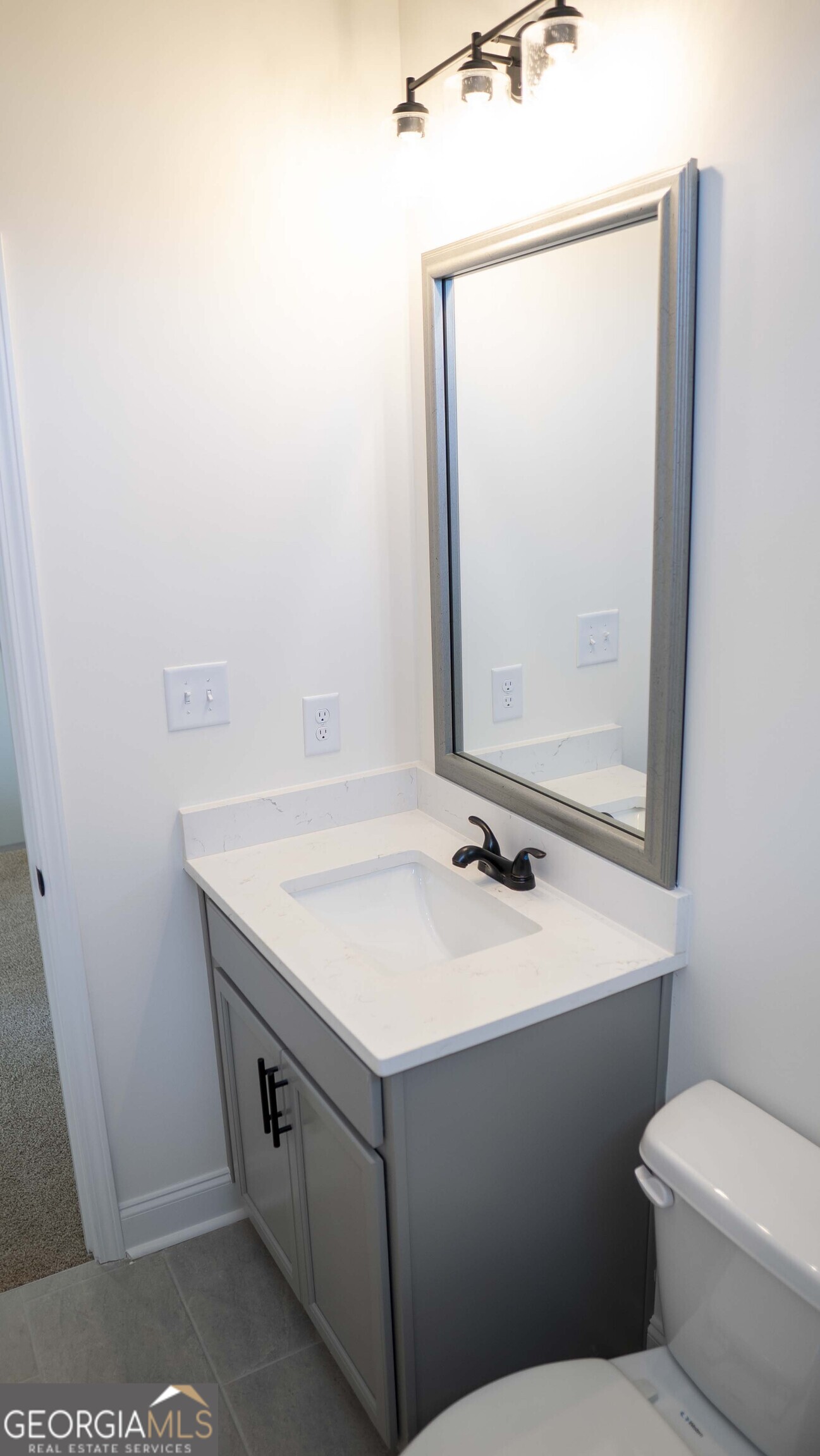 604 Beaver Court Perry, GA 31069 - Photo 28 of 40 a bathroom with a sink toilet and mirror