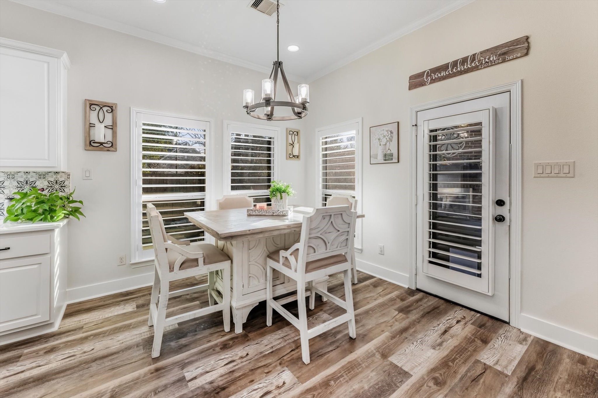 103 Fox Rindle Road Montgomery, TX 77316 - Photo 11 of 44 Sunlit dining space framed by plantation shutters offers an inviting setting for elevated everyday meals and intimate gatherings.