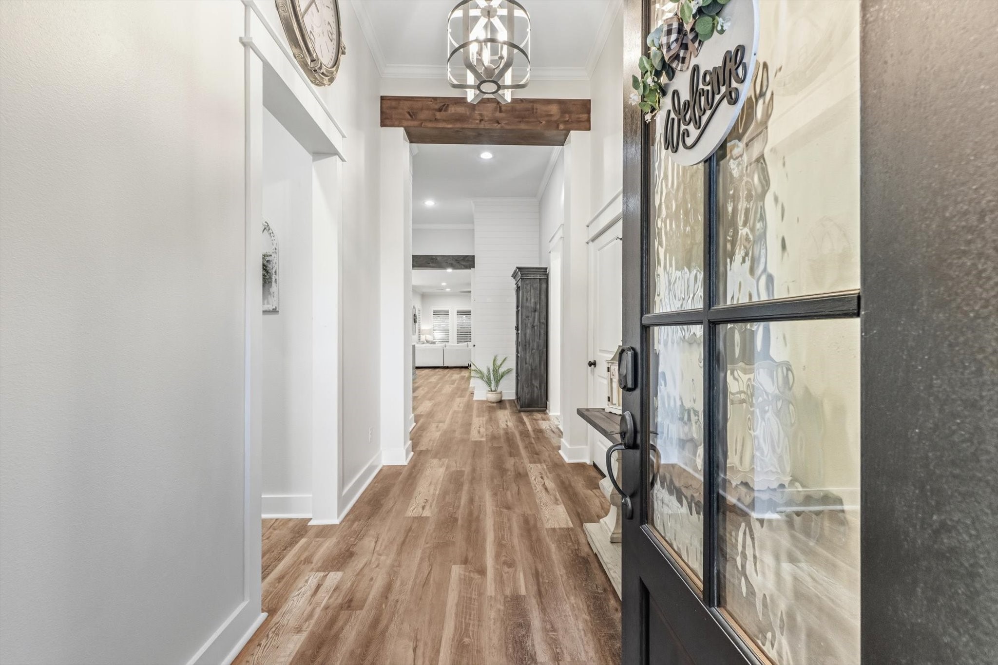 103 Fox Rindle Road Montgomery, TX 77316 - Photo 2 of 44 A sophisticated entry welcomes you with soaring ceilings, statement lighting, and rich wood-look plank flooring. Custom design details and refined finishes immediately signal the home’s elevated style.