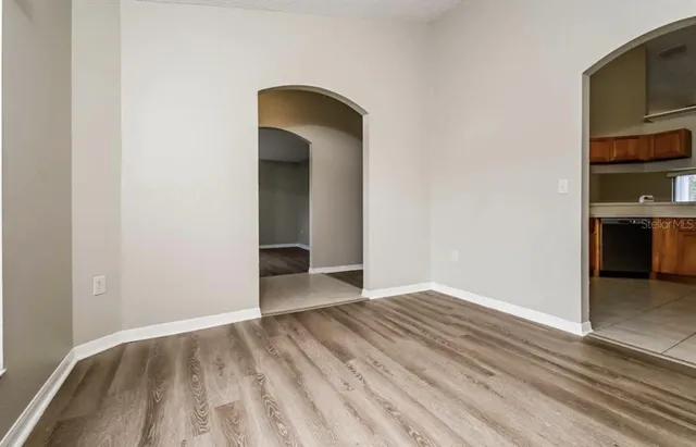 an empty room with wooden floor and closet