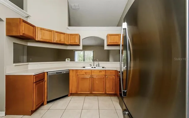 a kitchen with stainless steel appliances granite countertop a sink and a microwave