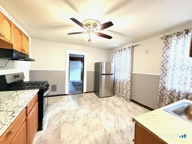 41-43 Washington Terrace Bridgeport, CT 06604 - Photo 7 of 18 a kitchen with stainless steel appliances kitchen island a stove a refrigerator and a sink