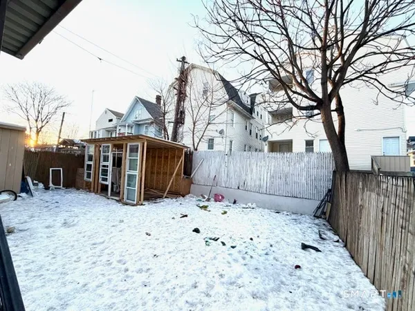 a view of a house with a snow on the road